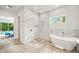 Modern bathroom with soaking tub, walk-in shower, and direct access to the main bedroom at 2327 Hillview St, Sarasota, FL 34239