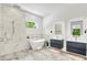 Modern bathroom with a soaking tub, a sleek shower, and dual floating vanities with LED mirrors at 2327 Hillview St, Sarasota, FL 34239
