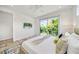 Cozy bedroom with king bed, ceiling fan, and sliding door access to the outdoor balcony at 2327 Hillview St, Sarasota, FL 34239