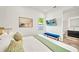 Modern bedroom with a blue bench, artwork, and bright window at 2327 Hillview St, Sarasota, FL 34239