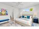 Bright bedroom with large bed, sleek decor, and an ensuite bathroom entrance at 2327 Hillview St, Sarasota, FL 34239