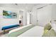Spacious bedroom with TV, a sleek bench, and access to other rooms at 2327 Hillview St, Sarasota, FL 34239