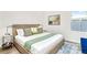 Bright bedroom featuring neutral decor, a large bed, and contemporary art at 2327 Hillview St, Sarasota, FL 34239