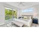 Bright bedroom features a king bed, ceiling fan, and sliding glass door to an outdoor balcony at 2327 Hillview St, Sarasota, FL 34239