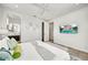 Stylish bedroom with king bed, modern decor, ensuite bathroom, and wall-mounted television at 2327 Hillview St, Sarasota, FL 34239