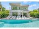 Modern two-story home with a private pool, sundeck, and balconies with glass railings at 2327 Hillview St, Sarasota, FL 34239