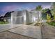 Modern home exterior with concrete driveway, a two-car garage and manicured landscaping at 2327 Hillview St, Sarasota, FL 34239