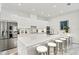 Modern kitchen featuring white cabinets, an island with barstool seating and stainless steel appliances at 2327 Hillview St, Sarasota, FL 34239