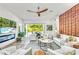 Bright living room with wood accent wall and an open floorplan to the outdoor patio at 2327 Hillview St, Sarasota, FL 34239