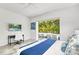 Modern main bedroom with a work station and poolside view, designed with elegant blue accents at 2327 Hillview St, Sarasota, FL 34239