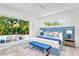 Beautiful main bedroom with king bed, blue accents, and poolside views through sliding glass doors at 2327 Hillview St, Sarasota, FL 34239