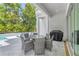 Outdoor patio features a dining table with chairs, outdoor grill, and lush pool in the backyard at 2327 Hillview St, Sarasota, FL 34239