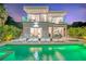 Modern home featuring a pool with lounge chairs and multiple balconies, perfect for outdoor relaxation at 2327 Hillview St, Sarasota, FL 34239