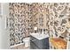 Stylish powder room featuring unique bird-themed wallpaper and contemporary fixtures at 2327 Hillview St, Sarasota, FL 34239
