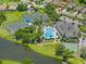 Aerial view of the community center featuring pool and tennis courts near a lake at 2334 Felicity Pl, North Port, FL 34289