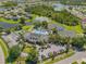 Beautiful community aerial showcasing clubhouse, tennis courts, pool, parking, and scenic ponds at 2334 Felicity Pl, North Port, FL 34289