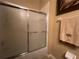 Bathroom features a bathtub with sliding glass door and a decorative towel at 2334 Felicity Pl, North Port, FL 34289