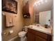 Bathroom featuring artwork, cabinet, toilet, light fixture and sink vanity at 2334 Felicity Pl, North Port, FL 34289
