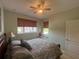 Cozy bedroom with a ceiling fan, natural light, window seat, and comfortable furnishings at 2334 Felicity Pl, North Port, FL 34289