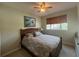 Comfortable bedroom with a palm-tree themed comforter, ceiling fan, and a cozy window seat at 2334 Felicity Pl, North Port, FL 34289