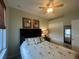 Well-lit bedroom with a ceiling fan, palm-tree patterned bedding, and closet with mirrors at 2334 Felicity Pl, North Port, FL 34289