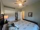 Bedroom featuring a ceiling fan, closet with mirror, and neutral decor at 2334 Felicity Pl, North Port, FL 34289