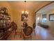 Elegant dining area with a glass table, stylish chairs, and a decorative chandelier at 2334 Felicity Pl, North Port, FL 34289