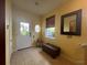 Bright foyer featuring tile floors, a bench, window, and a front door with glass at 2334 Felicity Pl, North Port, FL 34289