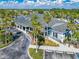 Aerial view of clubhouse featuring covered porch, ample parking and lovely landscaping at 2334 Felicity Pl, North Port, FL 34289