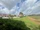 A view of well-maintained landscaping around residential buildings on a partly cloudy day at 2334 Felicity Pl, North Port, FL 34289
