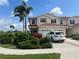 Beautiful townhome with an attached garage, lush landscaping, and a paver driveway at 2334 Felicity Pl, North Port, FL 34289
