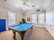 Bright game room with a beautiful pool table, large windows, ceiling fan, and nice neutral carpet at 2334 Felicity Pl, North Port, FL 34289