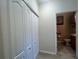 Hallway with closet leads to bathroom with toilet and sink at 2334 Felicity Pl, North Port, FL 34289