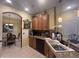 Charming kitchen with granite countertops, wooden cabinets, and a seamless transition to the dining area at 2334 Felicity Pl, North Port, FL 34289