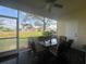 Relaxing screened lanai with a table, chairs, and a view of the lush surroundings at 2334 Felicity Pl, North Port, FL 34289