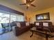 Cozy living room with modern furniture, tile flooring, and access to outdoor space at 2334 Felicity Pl, North Port, FL 34289