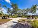 Charming picnic area with benches nestled amongst mature trees for outdoor enjoyment at 2334 Felicity Pl, North Port, FL 34289