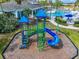 Exterior shot of playground with a slide, stairs, ladder and greenery surrounding it at 2334 Felicity Pl, North Port, FL 34289