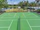 Bright and well-maintained community tennis court with lake and palm tree views at 2334 Felicity Pl, North Port, FL 34289