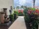 Inviting garden walkway with lush foliage, flowers, and an eye-catching waterfall feature at 2334 Felicity Pl, North Port, FL 34289