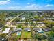 Charming neighborhood, featuring well-maintained homes, lush greenery, and inviting swimming pools under a sunny sky at 2361 Rose St, Sarasota, FL 34239