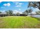 Large backyard featuring green grass and partial privacy fence at 2361 Rose St, Sarasota, FL 34239