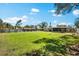 Large backyard featuring green grass and full privacy fence at 2361 Rose St, Sarasota, FL 34239