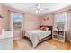 Bedroom featuring hardwood floors, ceiling fan and cheerful pink color at 2361 Rose St, Sarasota, FL 34239