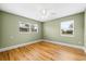 Bright bedroom with two windows, hardwood floors, and a ceiling fan at 2361 Rose St, Sarasota, FL 34239