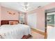 Bedroom featuring hardwood floors, ceiling fan and cheerful pink walls at 2361 Rose St, Sarasota, FL 34239
