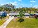 Charming single-story home with a well-manicured lawn and mature shade trees at 2361 Rose St, Sarasota, FL 34239