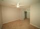 Comfortable bedroom featuring a ceiling fan, closet, and neutral walls with plush carpeting at 2384 Midnight Pearl Dr, Sarasota, FL 34240