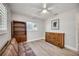 Cozy bedroom with wood floors, ceiling fan, and bright windows offers natural light at 2409 Wells Ave, Sarasota, FL 34232