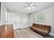 Neutral bedroom with wood floors, closet, ceiling fan, and bright windows with wood blinds at 2409 Wells Ave, Sarasota, FL 34232